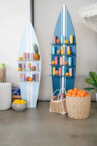 Surfboard display holding Alani Nu drinks at a themed event at PINE Charlotte
