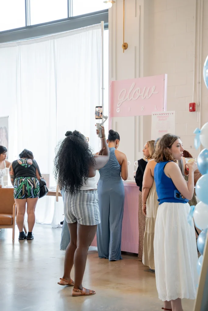 Women walking through a wellness event at PINE Charlotte, exploring vendor activations