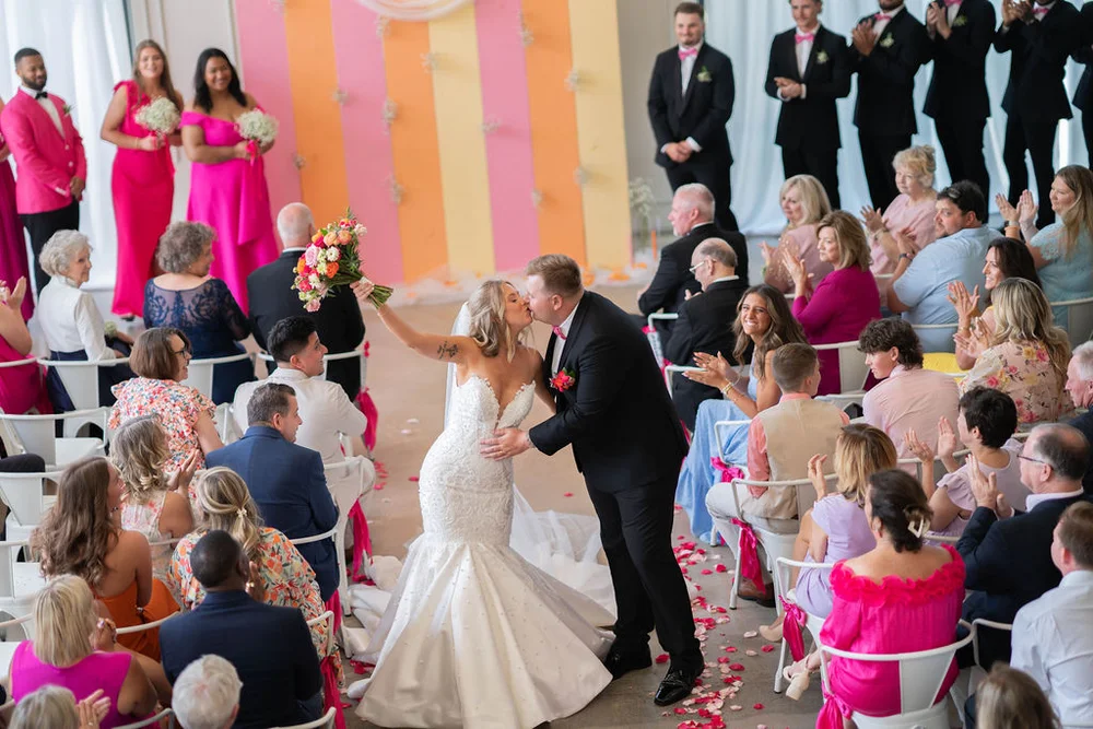 Bride and groom walking down the aisle after saying ‘I do’ and sharing a kiss at PINE Charlotte