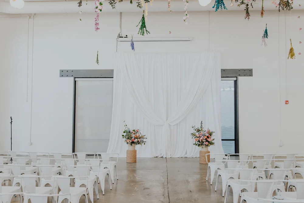 Wedding ceremony with a draping backdrop at PINE in Charlotte