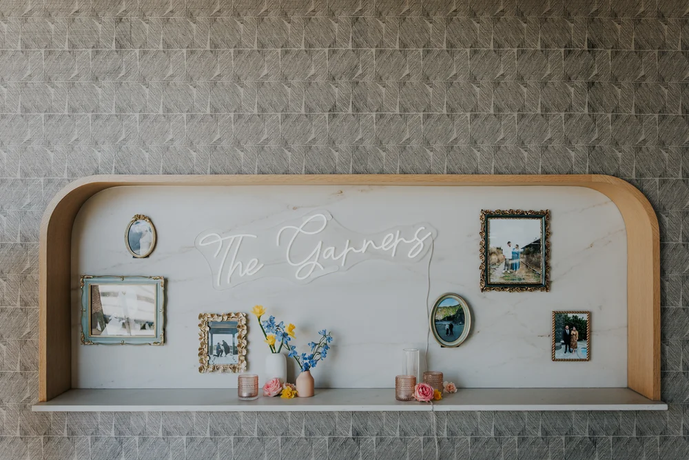 Shelf styled with wedding décor and a neon sign at PINE in Charlotte
