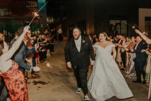 Bride and groom and their guests during a sparkler exit outside of PINE in Charlotte