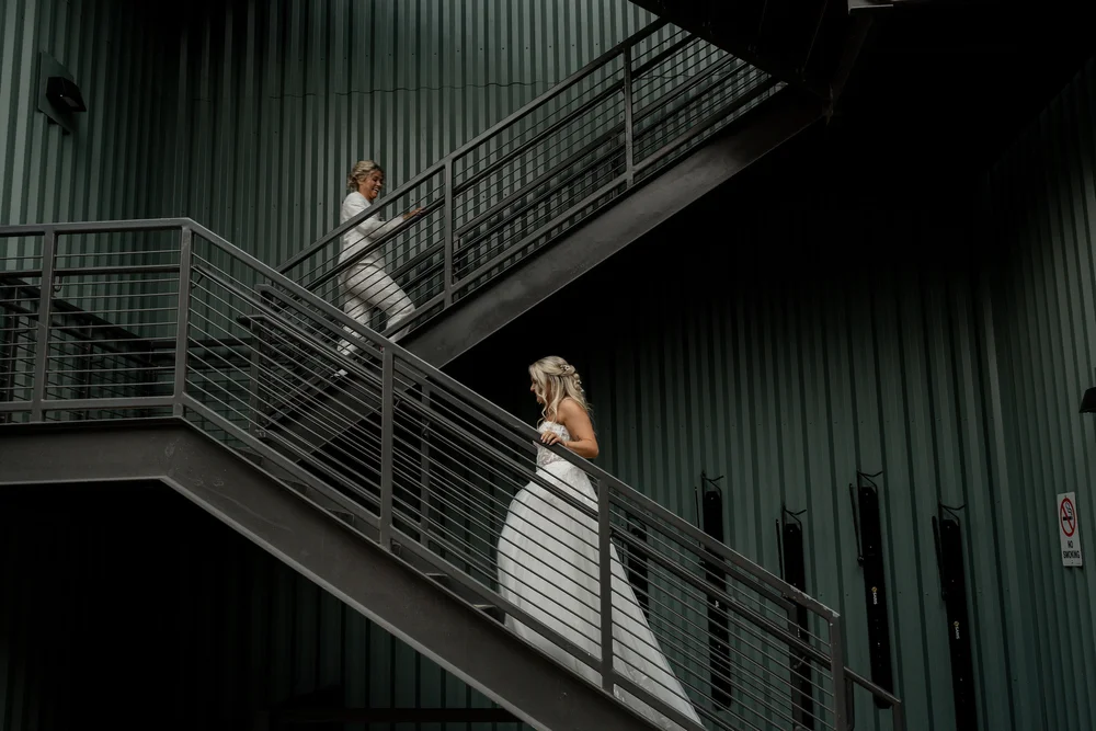 Brides on the stairs outside of PINE in Charlotte