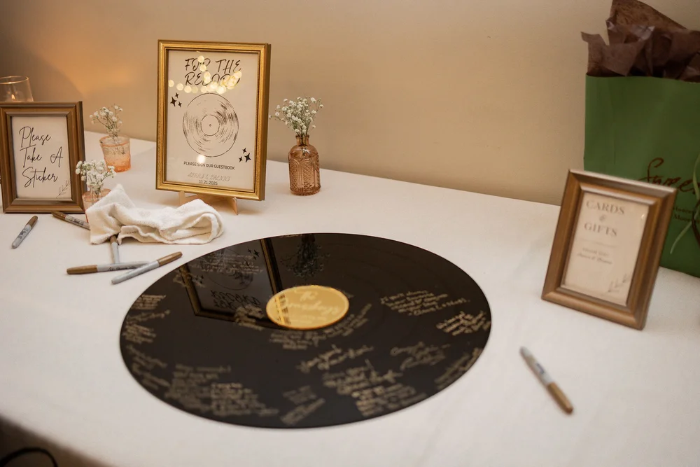 Vinyl record guest book at Sierra and Brenna's music-themed wedding at PINE in Charlotte